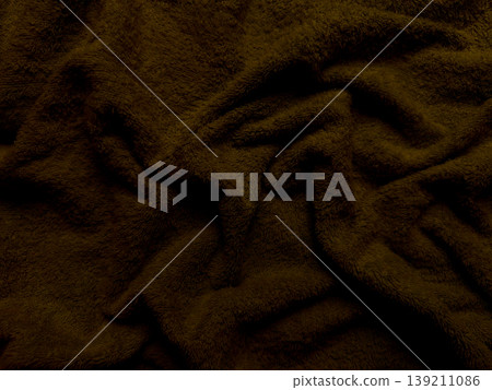 rich chocolate brown fuzzy fabric texture softly folding in closeup evoking cozy autumn warmth for wallpaper or banner background 139211086