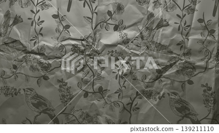 crumpled vintage botanical paper texture with flying birds and blooming flowers evoking nostalgic mood for wallpaper or editorial background crumpled vintage botanical paper texture with flying birds and blooming flowers evoking nostalgic mood for wallpaper or editorial background 139211110