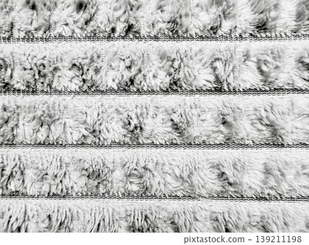abstract fluffy white shaggy texture horizontal rows soft fibrous pattern closeup serene grayscale backdrop for wallpaper or banner design abstract fluffy white shaggy texture horizontal rows soft fibrous pattern closeup serene grayscale backdrop for wallpaper or banner design 139211198