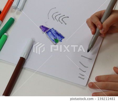 child's hands draw with the brush 139211481