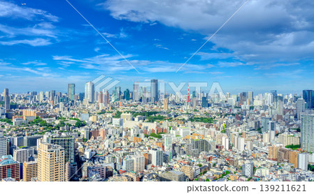 A cityscape of Tokyo's skyscrapers and high-rise buildings under a clear blue sky. A cityscape of Tokyo's skyscrapers and high-rise buildings under a clear blue sky. 139211621