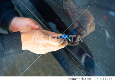 Removing dents on the car. PDR technology. Car body repair without painting. Removing dents on the car. PDR technology. Car body repair without painting. 139211757