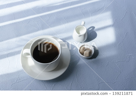Morning light and shadow by the window, a refreshing blue table photo for coffee time. Morning light and shadow by the window, a refreshing blue table photo for coffee time. 139211871