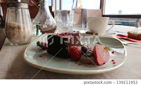 Chocolate Cake Dessert with Fresh Berries and Powdered Sugar Chocolate Cake Dessert with Fresh Berries and Powdered Sugar 139211952