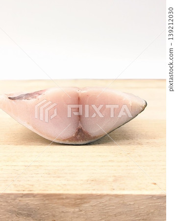 Close-up of a fresh fish fillet placed on a cutting board. Close-up of a fresh fish fillet placed on a cutting board. 139212030