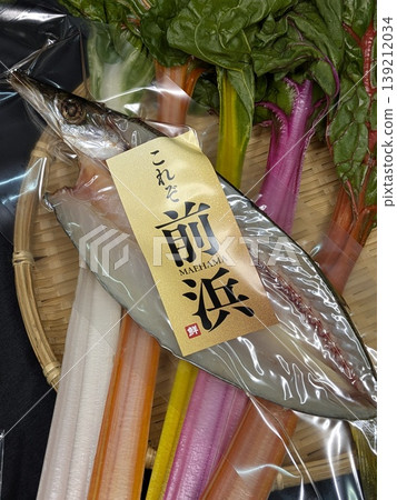 A set of dried fish (barracuda) from "Maehama" with a gleaming gold label and colorful rainbow chard vegetables. A set of dried fish (barracuda) from "Maehama" with a gleaming gold label and colorful rainbow chard vegetables. 139212034