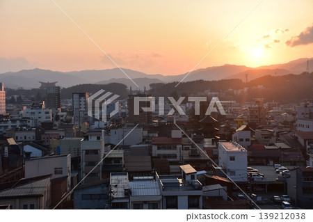 Takayama City, Gifu Prefecture, Japan - Aerial view of the cityscape and beautiful sunset from a high-rise building, facing the three-story pagoda in the city center Takayama City, Gifu Prefecture, Japan - Aerial view of the cityscape and beautiful sunset from a high-rise building, facing the three-story pagoda in the city center 139212038