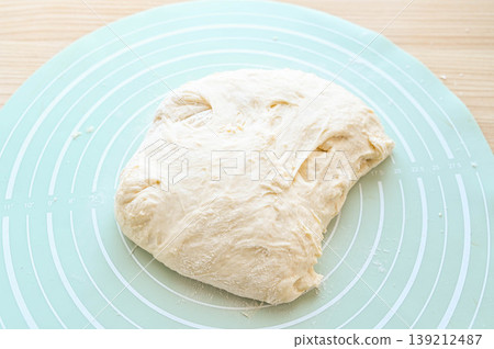 The ciabatta dough was placed on a baking mat. The ciabatta dough was placed on a baking mat. 139212487