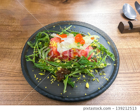 Plate of served salad with tuna, eggs, red caviar and arugula. Vibrant healthy and delicious food Plate of served salad with tuna, eggs, red caviar and arugula. Vibrant healthy and delicious food 139212513
