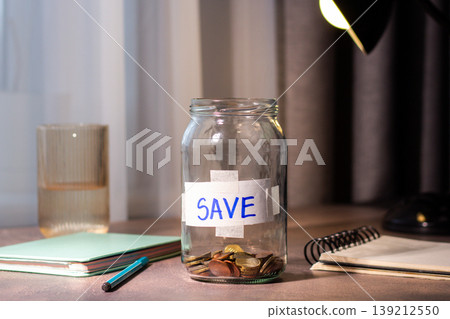 Close up of transparent money jar. Represents traditional saving methods and conscious money management for future security 139212550