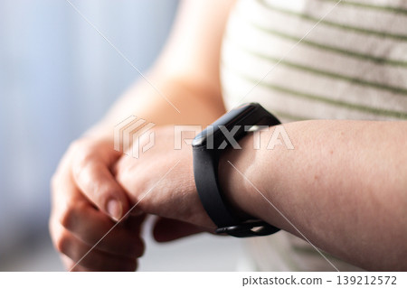 Smartwatch showing heart rate. Calm health tracking. Quiet shift from health anxiety to relaxed informed awareness. Human calm over digital urgency 139212572