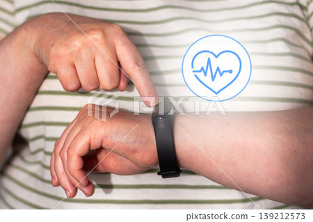 Woman checks health indicators using tracking app on smartwatch. Smart health means using devices as assistants not overlords. Low alarm high-awareness living. Digital detox concept Woman checks health indicators using tracking app on smartwatch. Smart health means using devices as assistants not overlords. Low alarm high-awareness living. Digital detox concept 139212573