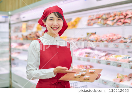 A young woman working at a supermarket's sample counter A young woman working at a supermarket's sample counter 139212663