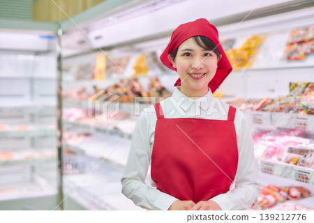 A young woman working at a supermarket's sample counter A young woman working at a supermarket's sample counter 139212776