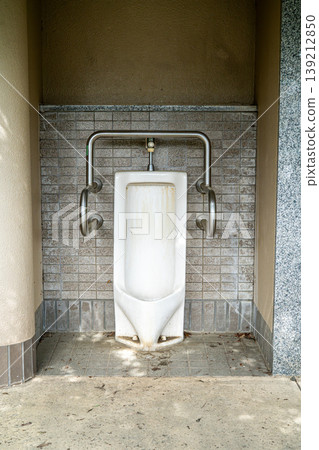 A slightly dirty men's restroom in a park 139212850