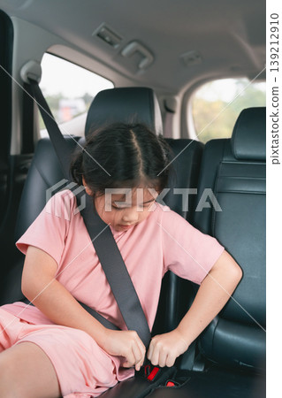 Young Girl Fastening Seatbelt in Car Safety Demonstration for Child Passenger Safety Education and Responsible Driving Practices Young Girl Fastening Seatbelt in Car Safety Demonstration for Child Passenger Safety Education and Responsible Driving Practices 139212910