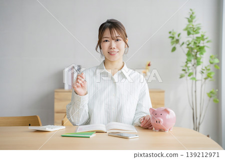 A woman holding a household account book 139212971