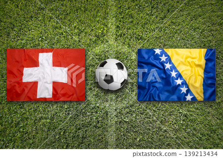 Switzerland vs. Bosnia and Herzegovina flags on a soccer field 139213434