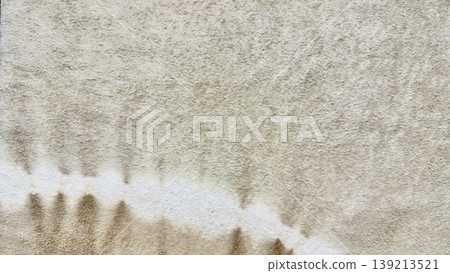 abstract brown ink drips forming stalactite waves on textured beige fabric in macro artistic closeup abstract brown ink drips forming stalactite waves on textured beige fabric in macro artistic closeup 139213521