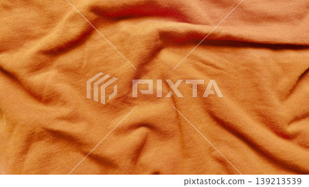 vibrant burnt orange jersey fabric undulates in soft rippling folds macro closeup evoking cozy autumn warmth texture background vibrant burnt orange jersey fabric undulates in soft rippling folds macro closeup evoking cozy autumn warmth texture background 139213539