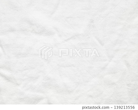 soft wrinkled white cotton fabric texture on pastel blue background capturing delicate folds subtle shadows minimalist closeup composition 139213556