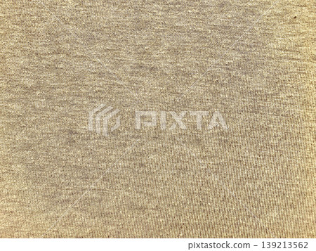 luxurious shimmering golden knit fabric texture closeup with warm beige hues and metallic threads evoking elegance and coziness 139213562