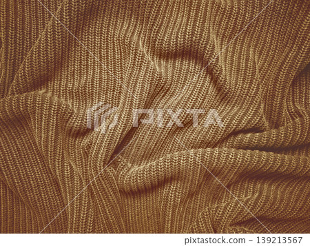 brown ribbed knit fabric texture undulating in soft warm folds evoking cozy vintage autumn comfort and tactile rustic charm brown ribbed knit fabric texture undulating in soft warm folds evoking cozy vintage autumn comfort and tactile rustic charm 139213567