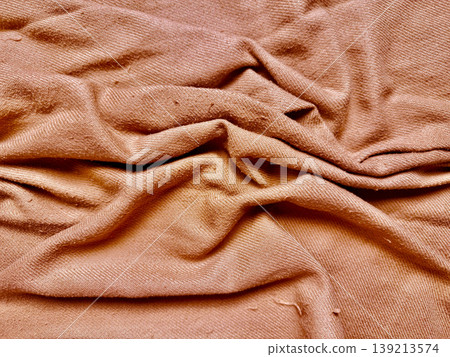 wrinkled tan fabric texture closeup with soft folds and earthy tones evoking cozy natural warmth wrinkled tan fabric texture closeup with soft folds and earthy tones evoking cozy natural warmth 139213574