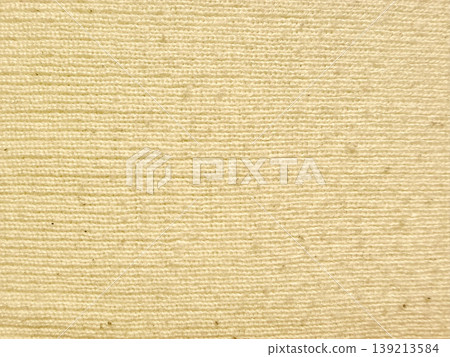 cream ribbed fabric texture closeup with soft horizontal ridges and warm beige tones evoking cozy minimalist design appeal in abstract material backdrop 139213584