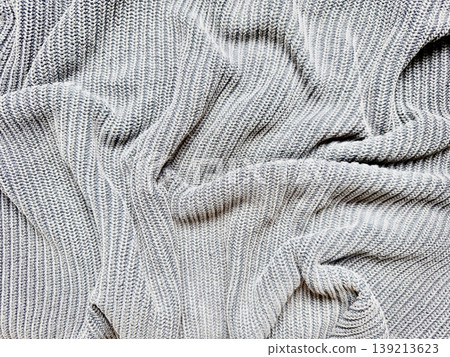 gray ribbed knit fabric soft texture close up elegant drapes folds cozy winter warmth tactile wool material abstract pattern gray ribbed knit fabric soft texture close up elegant drapes folds cozy winter warmth tactile wool material abstract pattern 139213623