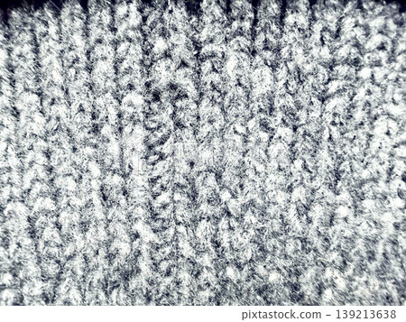 woolen knit texture closeup revealing intricate fibrous strands in grayscale tones radiating soft tactile warmth for winter designs 139213638