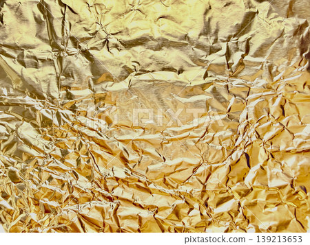shimmering crumpled gold foil texture abstract metallic background with luxurious wrinkles and radiant shine closeup shimmering crumpled gold foil texture abstract metallic background with luxurious wrinkles and radiant shine closeup 139213653