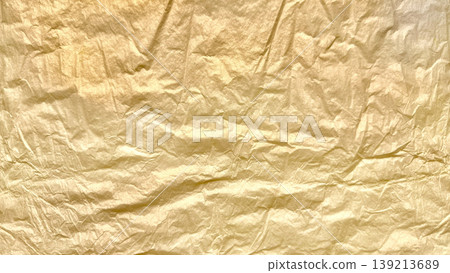 crinkled golden foil texture gleaming with subtle sheen abstract luxury background evoking opulence and vintage elegance 139213689