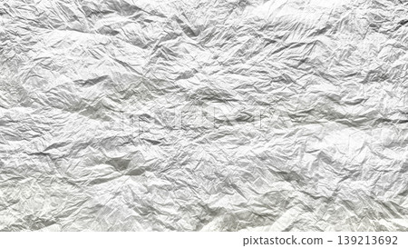 crumpled aluminum foil texture shimmering with intricate metallic wrinkles and reflective sheen on light blue backdrop 139213692