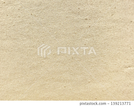 beige ribbed knit fabric texture closeup showcasing soft woven threads subtle shadows and gentle folds against pale blue backdrop evoking cozy tactile warmth beige ribbed knit fabric texture closeup showcasing soft woven threads subtle shadows and gentle folds against pale blue backdrop evoking cozy tactile warmth 139213771