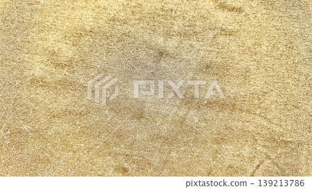shimmering gold fabric texture closeup with horizontal ridges and warm metallic glow for luxury backgrounds 139213786