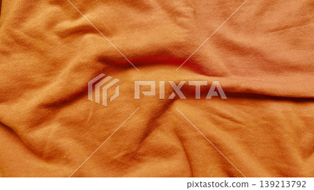 vibrant orange cotton fabric texture with soft folds and wrinkles in closeup evoking warm autumn coziness for design backgrounds vibrant orange cotton fabric texture with soft folds and wrinkles in closeup evoking warm autumn coziness for design backgrounds 139213792