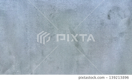 shimmering metallic mesh fabric texture in ethereal blue gray tones closeup abstract background with subtle glow shimmering metallic mesh fabric texture in ethereal blue gray tones closeup abstract background with subtle glow 139213896