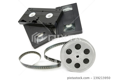 Vintage VHS Video Cassettes and 8mm Movie Film Reel Isolated on White Vintage VHS Video Cassettes and 8mm Movie Film Reel Isolated on White 139213950