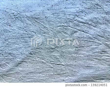 texture of crumpled blue fabric with scattered dark specks closeup texture of crumpled blue fabric with scattered dark specks closeup 139214051