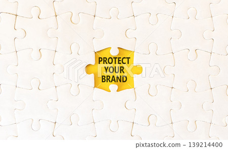 Protect your brand words symbol. Concept words Protect your brand on beautiful white puzzles. Beautiful yellow background. Business and protect your brand concept. Copy space. Protect your brand words symbol. Concept words Protect your brand on beautiful white puzzles. Beautiful yellow background. Business and protect your brand concept. Copy space. 139214400