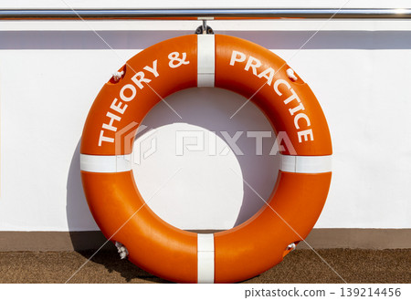 Theory and practice symbol. Concept words Theory and practice on beautiful orange lifebuoy. Beautiful white ship's board background. Business theory and practice concept. Copy space. Theory and practice symbol. Concept words Theory and practice on beautiful orange lifebuoy. Beautiful white ship's board background. Business theory and practice concept. Copy space. 139214456
