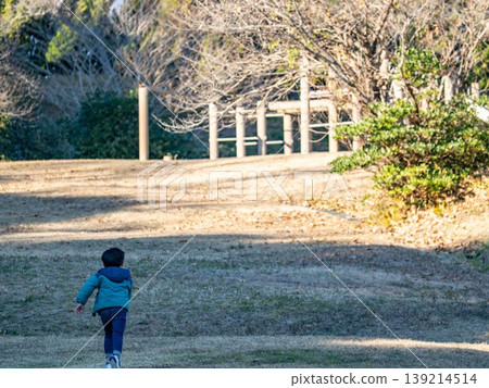 A boy playing in a park A boy playing in a park 139214514