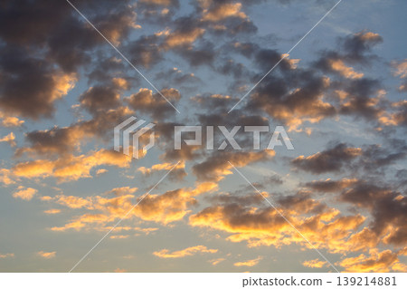 Sunset sky covered with orange puffy clouds in the evening. Sunset sky covered with orange puffy clouds in the evening. 139214881