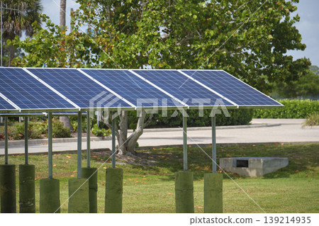 Solar panels installed on stand frame near parking lot for effective generation of clean electricity. Photovoltaic technology integrated in urban infrastructure for electric car charging Solar panels installed on stand frame near parking lot for effective generation of clean electricity. Photovoltaic technology integrated in urban infrastructure for electric car charging 139214935