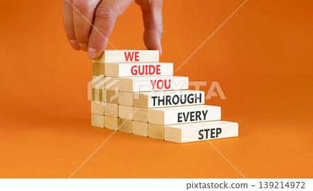 We guide you through every step symbol. Concept words We guide you through every step on wooden sticks. Beautiful orange paper background. Business We guide you through every step concept. Copy space. 139214972
