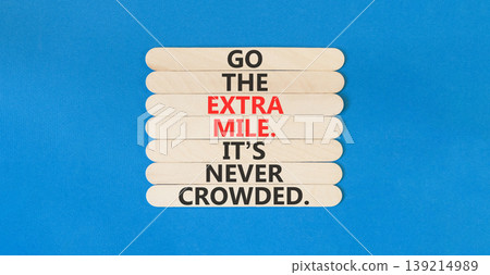 Go the extra mile symbol. Concept words Go the extra mile. It's never crowded on beautiful wooden sticks. Beautiful blue paper background. Business go the extra mile concept. Copy space. Go the extra mile symbol. Concept words Go the extra mile. It's never crowded on beautiful wooden sticks. Beautiful blue paper background. Business go the extra mile concept. Copy space. 139214989