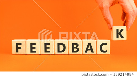 Feedback word symbol. Concept word Feedback on beautiful wooden blocks. Beautiful orange background. Businessman's hand. Business support help feedback word concept. Copy space. Feedback word symbol. Concept word Feedback on beautiful wooden blocks. Beautiful orange background. Businessman's hand. Business support help feedback word concept. Copy space. 139214994