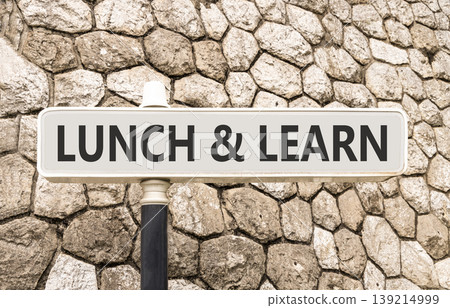 Lunch and learn symbol. Concept words Lunch and learn on beautiful big white road sign. Beautiful grey stone wall background. Business, educational and lunch and learn concept. Copy space. 139214999