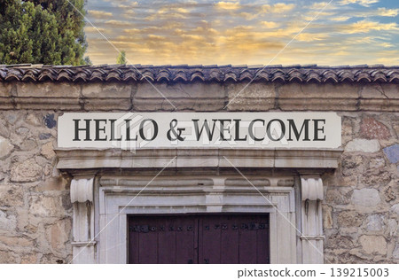 Hello and welcome symbol. Concept words Hello and welcome on beautiful big marble white sign plate. Beautiful old stone wall background. Business hello and welcome concept. Copy space. Hello and welcome symbol. Concept words Hello and welcome on beautiful big marble white sign plate. Beautiful old stone wall background. Business hello and welcome concept. Copy space. 139215003